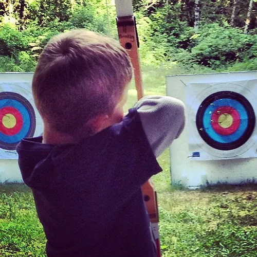 Close-up of an archery competition sight being adjusted on a tournament bow
