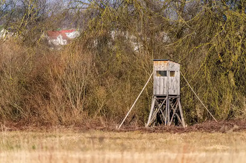 DIY archery target stand made from lumber with braces and a target bag outdoors