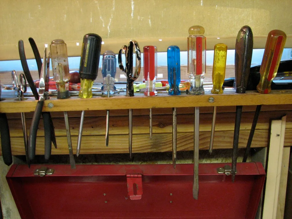Wood samples, bolts, and a tape measure on a workbench for a DIY archery target stand