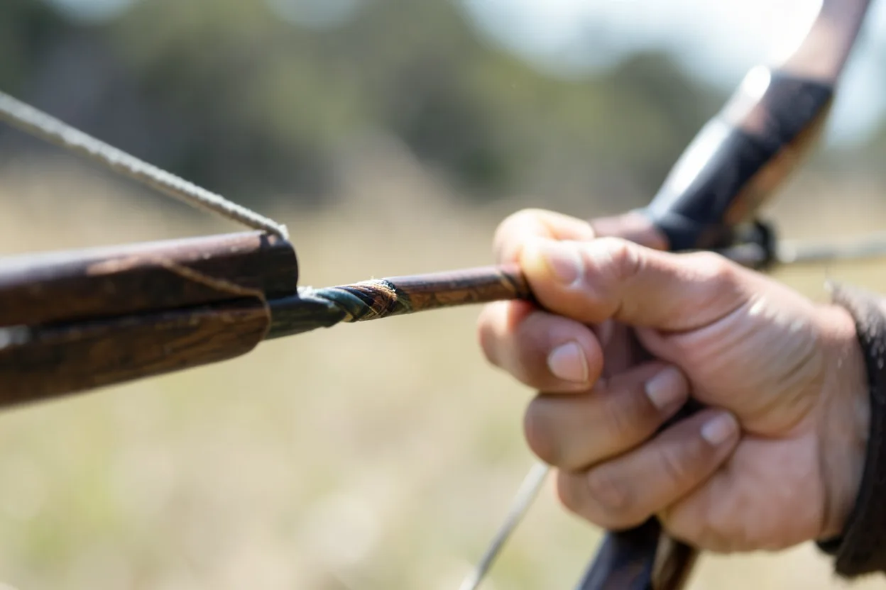 Close-up of bow hand and nocked arrow on a Native American style bow