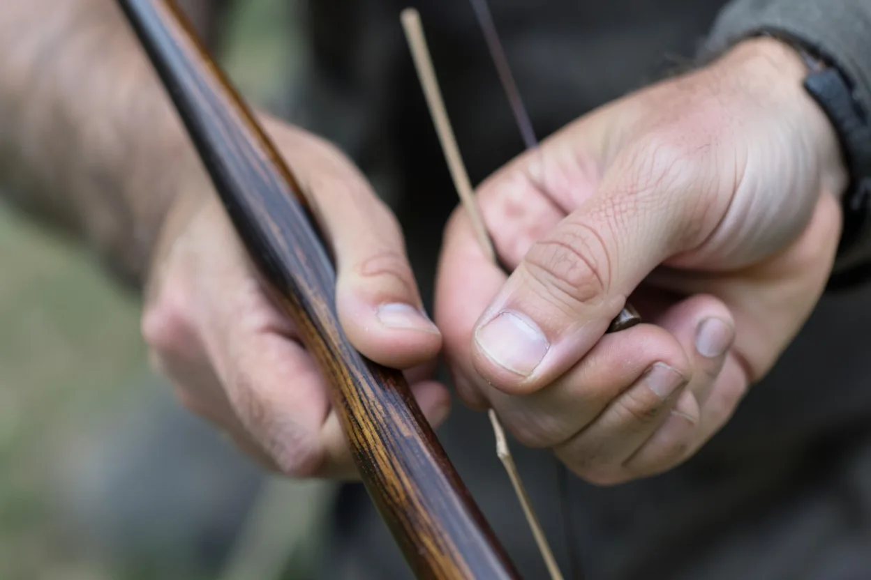 Close-up of hand placement on a self bow and recurve showing grip differences for control