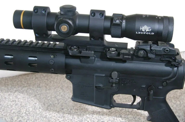 Hunter checking a Talley peep sight mounted on a rifle at a workbench