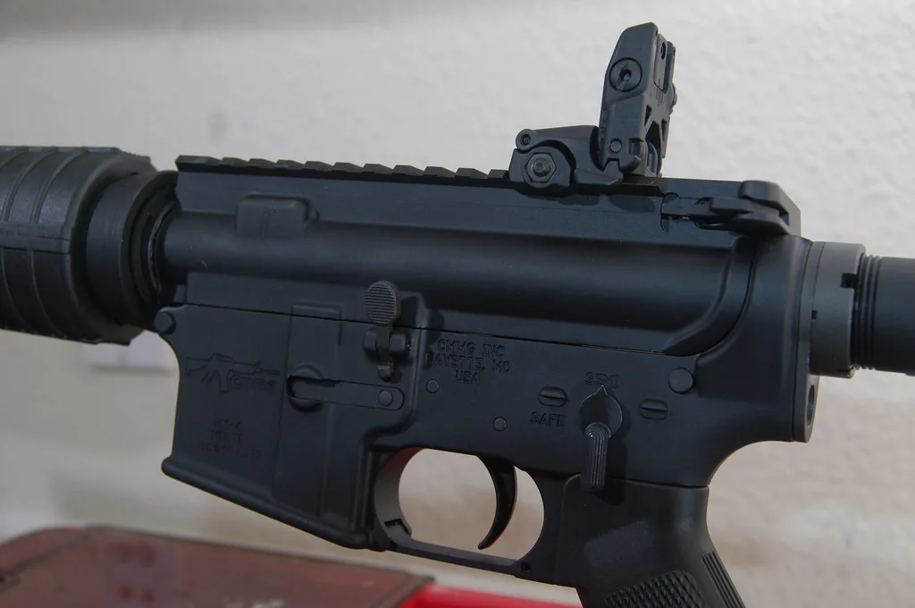 Close-up of a hand adjusting a Talley peep sight on a rifle receiver