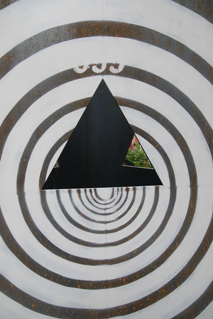 A DIY target stand with lumber, hardware, and a foam archery target in a backyard