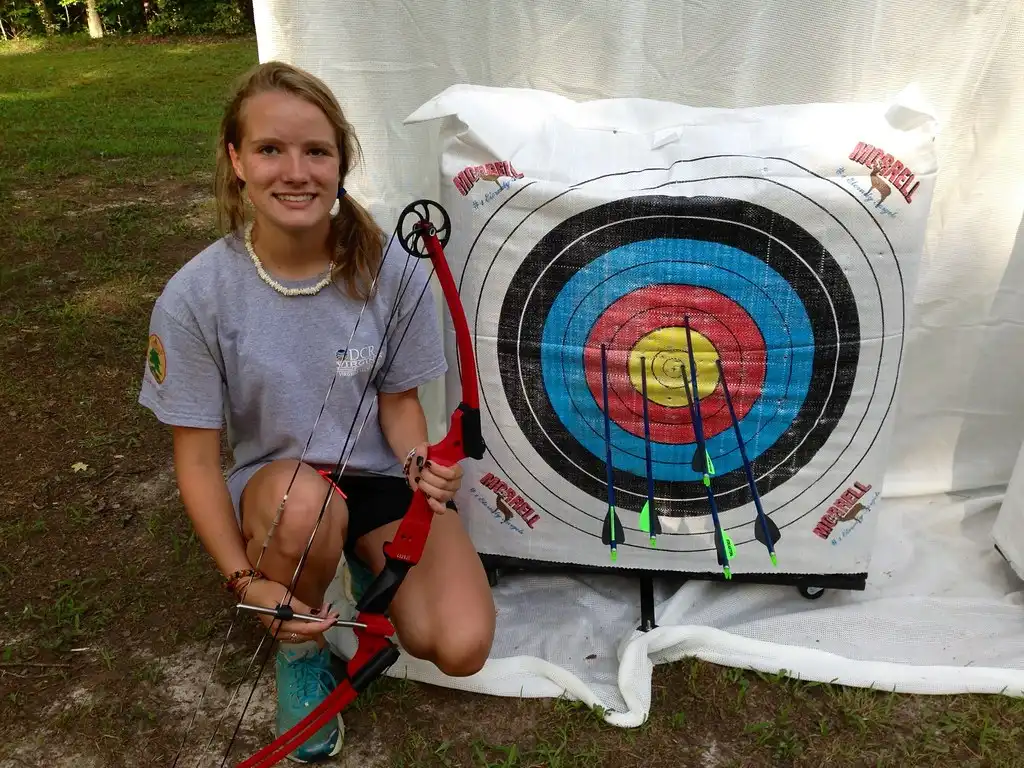 Close-up of a bowstring near an archer's cheek showing facial contact risk