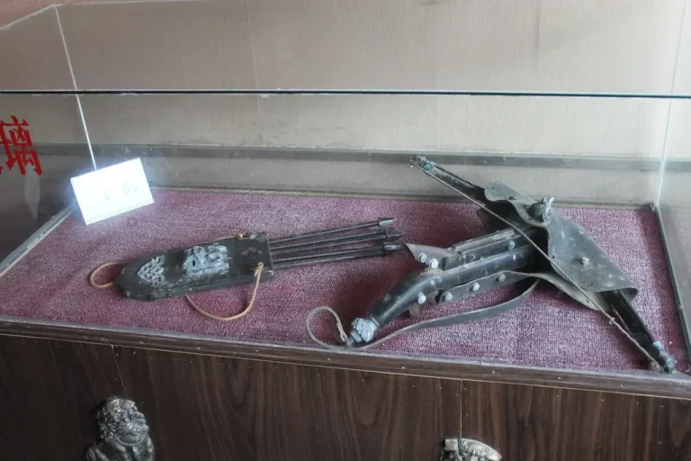Ravin crossbow and arrows on a workbench with calipers, broadheads, and notes