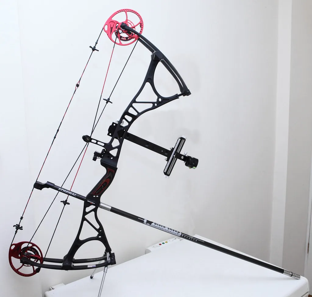 Compound archer at full draw with a wrist strap release aid on a target range