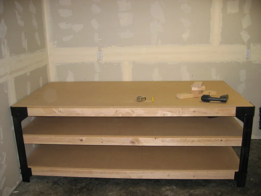 Close-up of a DIY target stand joint with screws, wood grain, and slight splitting